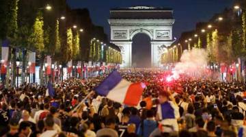 SUASANA HEBAT: Puluhan ribu penyokong berpesta meraikan kejayaan Perancis melangkah ke pentas final selepas menewaskan Belgium di Champs-Elysees, Paris kelmarin. — Gambar Reuters