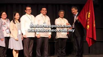 SERAH: Loh (kanan) menyerahkan bendera Kongres Produksi Haiwan Asia-Australasian kepada wakil tuan rumah Filipina Dr Arnel N Del Barrio bagi penganjuran 2020.