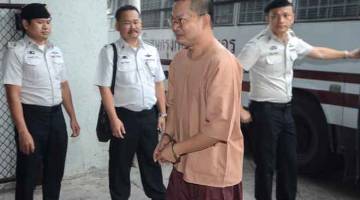 DIHUKUM PENJARA: Anggota pasukan keselamatan berkawal ketika Wiraphon (bergari) tiba               untuk perbicaraannya di Mahkamah Jenayah di Bangkok, Thailand semalam. — Gambar Dailynews/Reuters