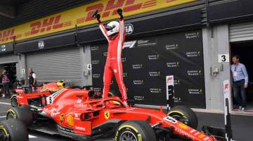 UNGGUL: Vettel ceria selepas selepas memenangi perlumbaan Grand Prix Belgium di Litar SPA-FRANCORCHAMPS, Belgium Ahad  lepas. — Gambar AFP