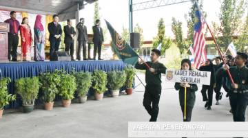 KEVIN (empat dari kiri) menyaksikan lintas hormat oleh Kadet Remaja Sekolah SMK Putatan dan unit beruniform SMK Putatan.