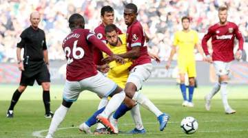 TIDAK BERI PELUANG: Hazard (tengah) diasak hebat oleh tiga pemain West Ham ketika beraksi pada perlawanan liga di Stadium London, England pada Ahad lepas.  — Gambar Reuters