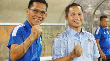 HENRY Saimpon (kanan) bersama Ketua Jurulatih Sabah Jelius Ating ketika Tambadau membenam PDRM 3-1 di Stadium Likas Sabtu lalu.