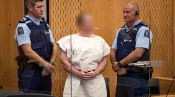 PADAH DITERIMA: Tarrant yang didakwa atas tuduhan membunuh berhubung serangan masjid, kelihatan dalam kandang tertuduh ketika dihadap ke Mahkamah Daerah Christchurch, New Zealand semalam. — Gambar Reuters