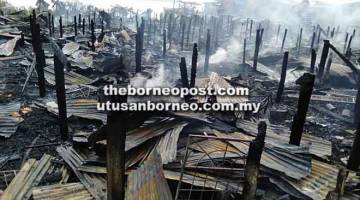 PUNAH: Kebakaran di Kampung Keramat memusnahkan 12 rumah, sebuah balai raya dan sebuah gereja SIB dengan keluasan kebakaran kira-kira 100m panjang x 50m lebar.