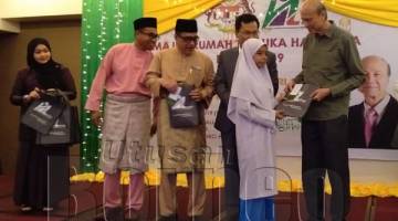 LEE (kanan) menyampaikan sumbangan duit raya kepada penghuni Rumah Anak As Sakinah, Papar.