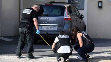 MENCARI PETUNJUK: Anggota polis memeriksa kawasan di luar sebuah masjid selepas dua orang cedera ditembak di Brest, Perancis kelmarin. — Gambar AFP
