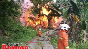 MUSNAH: Anggota bomba memadam sisa bara api daripada merebak.