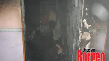 HAMPIR MUSNAH: Sebuah rumah PPR Jalan Lintas Sibuga terbakar.