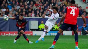 JARINGAN CANTIK:  Willian (tengah) melepaskan rembatan  volley sebelum menjaringkan gol kedua Chelsea pada aksi di Lille, Perancis kelmarin. — Gambar AFP 