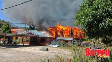 TERBAKAR: Api marak yang memusnahkan dua buah rumah di Kampung Lumadan Jaya di sini.