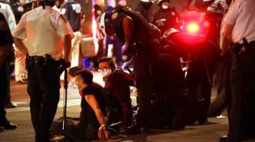  Penunjuk perasaan yang tidak mengendahkan perintah berkurung ditangkap selepas mereka kembali ke jalan raya di Manhattan, New York pada malam kelmarin untuk memprotes tindakan polis membunuh Floyd. — Gambar AFP