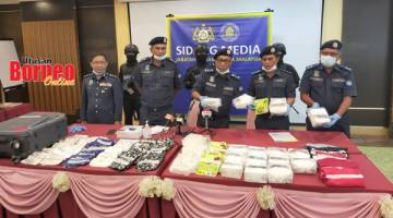 SITA: Abdullah (tengah) menunjukkan bungkusan dadah jenis Methamphetamine yang disita pada 13 September lalu.
