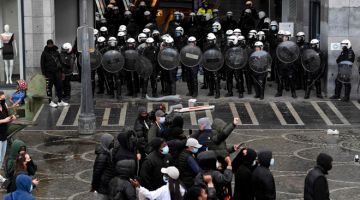 TEMPUR: Polis antirusuhan Belgium bertempur dengan penunjuk perasaan di hadapan sebuah pusat beli belah di Liege, Belgium. — Gambar AFP