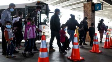 SEKAT KEMASUKAN: Pendatang dari benua Amerika Selatan tiba di stesen bas Pejabat Kastam  dan Kawalan Sempadan AS berdekatan Jambatan Antarabangsa Gateway di antara Brownsville Texas dan Matamoros, Mexico. — Gambar AFP