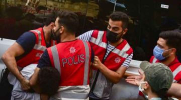 HURU-HARA: Polis memberkas penunjuk perasaan selepas lelaki bersenjata menyerbu pejabat wilayah parti pro-Kurdish dan membunuh seorang wanita di Istanbul, kelmarin. — Gambar AFP
