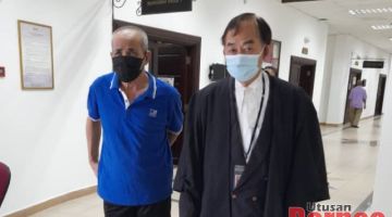 Tertuduh (kiri) bersama peguamnya, Lim Lian Kee semasa berada di lobi Mahkamah Kuching.