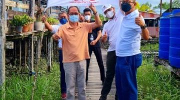 Abdullah dan warga kampung bersama bendera GPS di sebuah lokasi dalam DUN Semop semasa kempen.  