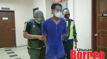 PADAH: Suryan Sah diiring keluar selepas prosiding mahkamah dijalankan.