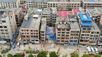 Pandangan udara menunjukkan anggota penyelamat menggeledah bangunan enam tingkat yang runtuh di Changsha, wilayah tengah Hunan di China kelmarin. — Gambar AFP