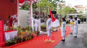 MERDEKA: Heni menyaksikan pengibaran bendera Indonesia sempena majlis tersebut.