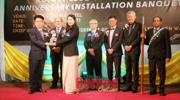 WATIKAH: Vivian (tiga kiri) menerima watikah pelantikan sebagai presiden Kelab Rotary Tawau.