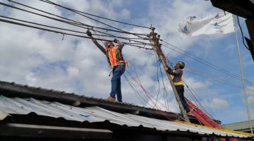 BANTERAS: Kakitangan SESB menjalankan operasi membuka pepasangan haram yang dipasang di tiang elektrik utama di Kampung Numbak.