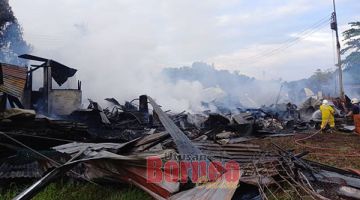 MUSNAH: Pasukan bomba menjalankan pemeriksaan bagi memastikan kawasan kebakaran selamat.