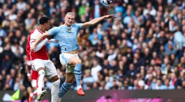 Pemain pertahanan Arsenal Gabriel Magalhaes (kiri) bersaing mendapatkan bola dengan penyerang Manchester City Erling Haaland perlawanan Liga Perdana Ingeris di antara Manchester City dan Arsenal di Stadium Etihad di Manchester, kelmarin. — Gambar AFP