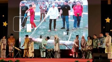 Abang Johari (tiga kiri), Wan Junaidi (lima kiri), Dr Annuar (enam kanan) sambil disaksikan yang lain sedang membakar meriam buluh sebagai simbolik perasmian Majlis Ramah Tamah Hari Raya Aidilfitri Bahagian Sibu pada malam Sabtu.