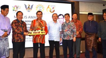 Dominic (dua kiri) menyampaikan cenderamata kepada Dr Rundi sambil disaksikan Sirai (empat kanan), Timbalan Menteri M-FICORD Datuk Martin Ben (lima kanan) dan Datuk Dr Abdul Rahman Ismail (kiri), Penasihat di Pejabat Premier Sarawak Tan Sri William Mawan Ikom (tiga kanan) serta tetamu lain.