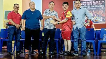 Chambai (tengah) menyampaikan tanda penghargaan kepada pengadil yang terlibat dalam Pertandingan Badminton Piala SDNU Sibu 2024.