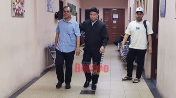 BERSALAH: Ahmad Rudi (kiri) diiring keluar selepas prosiding mahkamah dijalankan. 