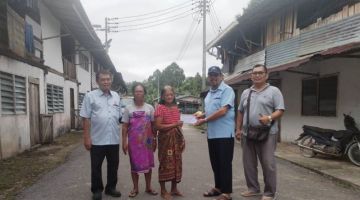 Mohd Ibrahim (empat kiri) menyampaikan sumbangan khairat kepada balu Nanang Salang sambil disaksikan oleh ahli PBPM yang lain. 