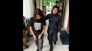 DIDAKWA: Li dibawa keluar dari kamar Mahkamah Majistret semalam.