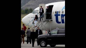 SELAMAT TIBA: Trudeau turun dari pesawat gantian, selepas pesawat kempennya rosak akibat dilanggar bas media, setibanya untuk acara kempen pilihan raya parti Liberal di Kamloops,             British Columbia, Kanada kelmarin. — Gambar Reuters