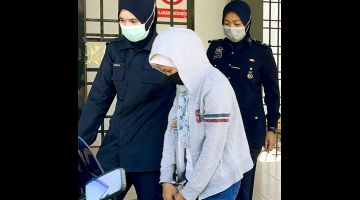 Wanita warga Indonesia diiringi polis selepas selesai prosiding, hari ini. - Gambar Bernama 
